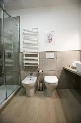 a bathroom with a toilet and a sink and a shower at Colosseum Maison in Rome