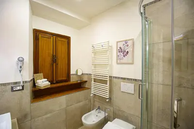a bathroom with a shower and a toilet and a sink at Colosseum Maison in Rome