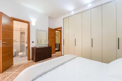 a bedroom with a large bed and a tv at Luigi's Home, Cozy Apartment Metro San Paolo in Rome