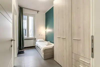 a small bedroom with a bed and a window at New Flat Near Termini Station in Rome