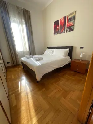 a bedroom with a bed and a wooden floor at A due passi da San Pietro in Rome