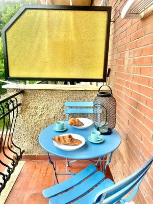 a blue table with two plates of food and two chairs at San Peter loft in Rome