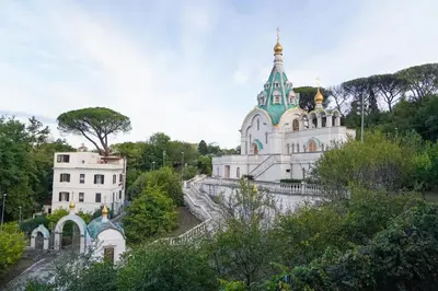 a white church with a blue turret and a building at San Peter loft in Rome