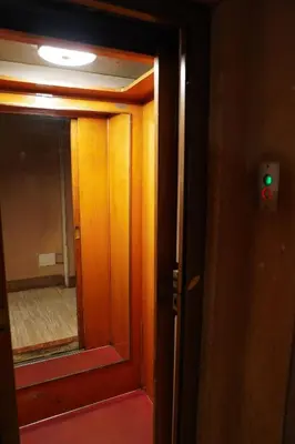 an open door with a mirror and a green light at San Peter loft in Rome