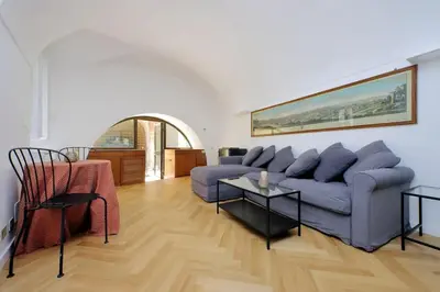 a living room with a blue couch and a table at Pantheon Apartment with private terrace in Rome
