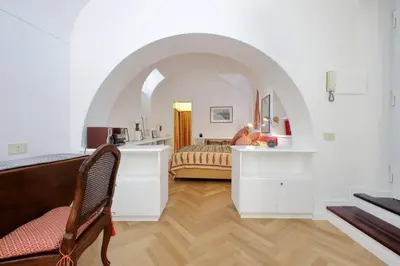 a bedroom with a bed in a room with an archway at Pantheon Apartment with private terrace in Rome