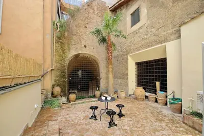 a courtyard with a palm tree in front of a building at Pantheon Apartment with private terrace in Rome