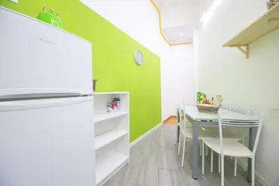 a dining room with a table and a green wall at Vatican Apartment - Sister's Place in Rome