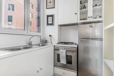 a kitchen with a stainless steel refrigerator and a sink at Casa Caracciolo Roma Vaticano in Rome
