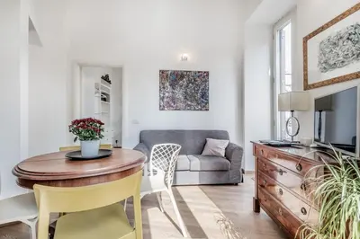 a living room with a table and a couch at Casa Caracciolo Roma Vaticano in Rome