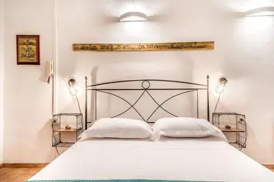 a bedroom with a white bed with two white pillows at Vatican Blue Sky in Rome