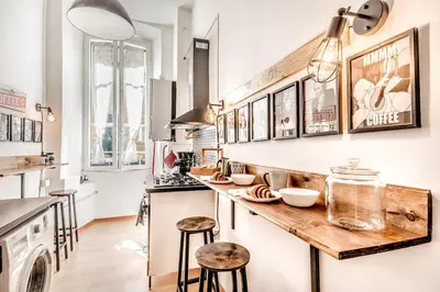 a kitchen with a wooden counter and stools at Vatican Blue Sky in Rome