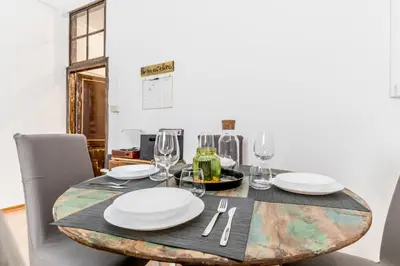 a table with plates and wine glasses on it at Vatican Blue Sky in Rome