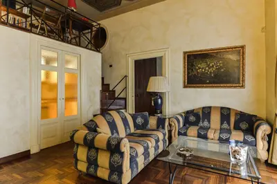a living room with two couches and a table at Parione Suite Piazza Navona in Rome