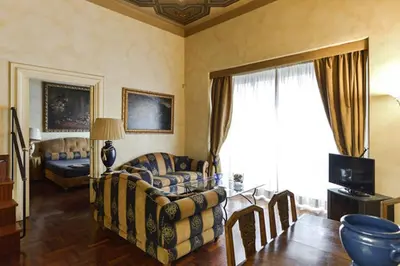 a living room with a couch and a table at Parione Suite Piazza Navona in Rome