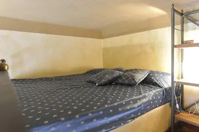 a bedroom with a bed with blue sheets and pillows at Parione Suite Piazza Navona in Rome