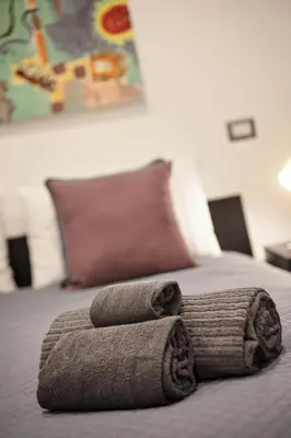 a pile of towels sitting on top of a bed at Navona Comfort House in Rome