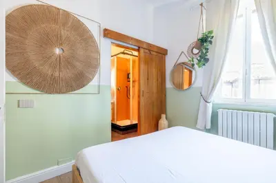 a bedroom with a white bed and a window at Milo Apt - Trastevere's Gem in Rome
