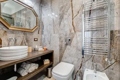 a bathroom with a sink toilet and a mirror at Roma in Relax Lovely Loft in the center of Rome Fabrizia in Rome