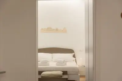 a bedroom with a bed and a mirror at Colosseum Holidays - Three-Bedroom Apartment in Rome