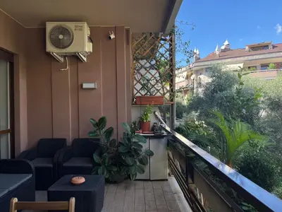 a balcony with a couch and a tv on the side at Moderno bilocale con terrazzo in Rome
