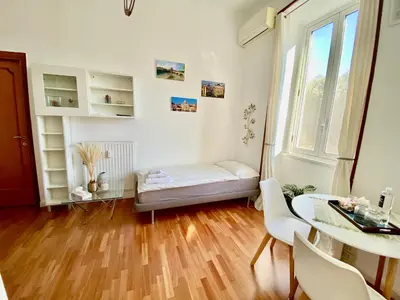 a small room with a bed and a table at Casa Blu Testaccio in Rome