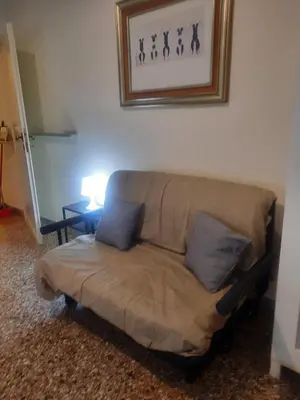 a couch with two pillows in a living room at Nido Vidaschi in Rome