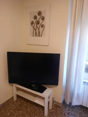 a flat screen tv sitting on a white tv stand at Nido Vidaschi in Rome