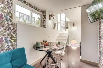 a small dining room with a table and a blue chair at Terrazza Ippocrate in Rome