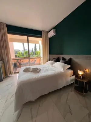 a bedroom with a large white bed and a large window at Aurelia Green Suite in Rome