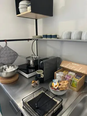 a kitchen counter with a coffee maker and some food at Aurelia Green Suite in Rome