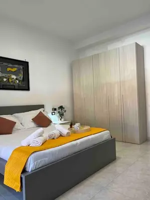 a bedroom with a bed with towels on it at 3 FERMATE DAL COLOSSEO - Casa Vacanze Elena - 50 m da METRO GARBATELLA in Rome