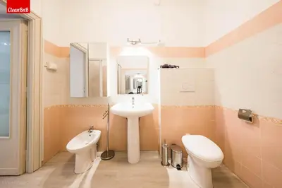 a bathroom with a sink and a toilet and a mirror at GuestHost - La finestra sui palazzi di Roma Apartment in Rome