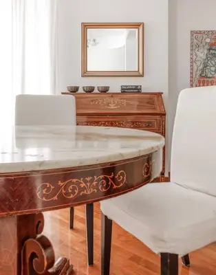 a wooden desk with a white chair and a mirror at Vatican Museum Apartment - ZENO 26 in Rome