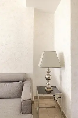 a lamp sitting on a table next to a couch at Casa Caterina - Modern design apartment near Vatican City in Rome