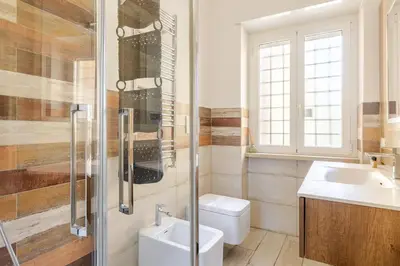 a bathroom with a toilet and a sink and a shower at Casa Caterina - Modern design apartment near Vatican City in Rome