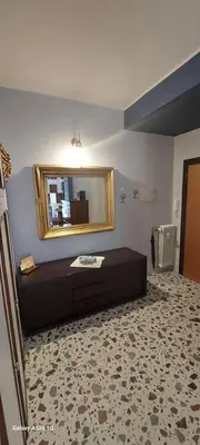 a bathroom with a mirror on the wall and a couch at Tra le antiche mura e Garbatella in Rome