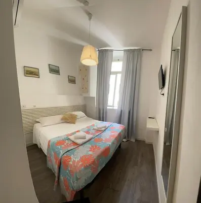 a small bedroom with a bed and a window at Vaticano San Pietro metro ottaviano in Rome