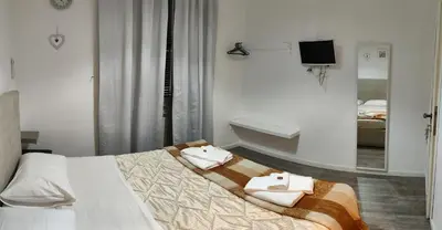 a bedroom with a bed with towels on it at Vaticano San Pietro metro ottaviano in Rome