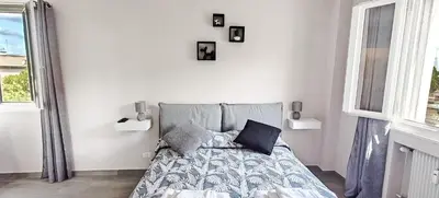 a bedroom with a bed and two windows at Rome Essence Apartament in Rome