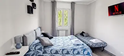 a small bedroom with a bed and a table at Rome Essence Apartament in Rome
