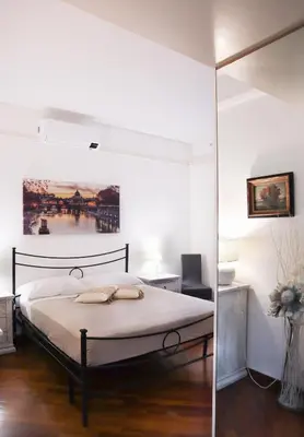 a bedroom with a bed and a glass wall at Cozy Home San Giovanni in Rome