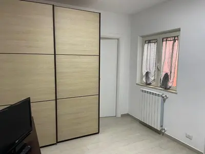 a living room with a large wooden closet at BORGO PESCI in Rome