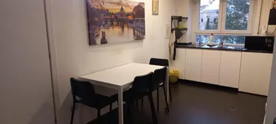 a kitchen with a table and chairs in a room at Casa Felicita in Rome