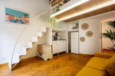 a living room with stairs and a yellow couch at Trevi Apartment in Rome