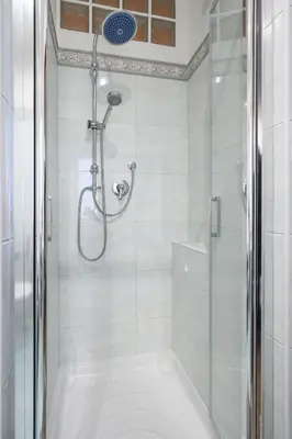 a bathroom with a shower with a glass door at Appartamento Barsanti in Rome