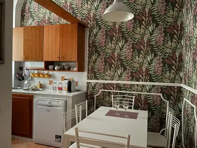 a kitchen with a table and chairs and a kitchen with a wallpaper at Prope Vaticanum in Rome