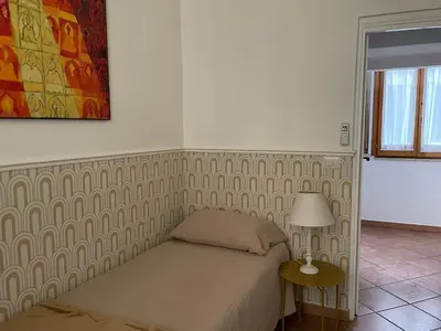 a bedroom with a bed and a table with a lamp at Prope Vaticanum in Rome