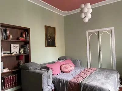 a bedroom with a bed with a pink pillow at Prope Vaticanum in Rome