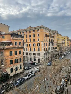 a city street with cars parked in front of buildings at Prope Vaticanum in Rome